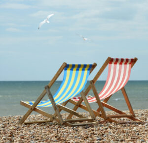 Two chairs on the beach on a sunny day. 